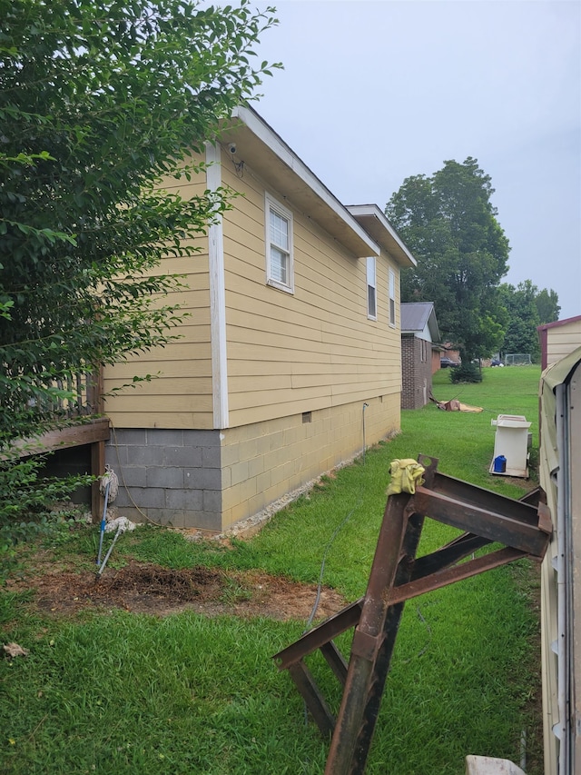 view of side of property with a yard