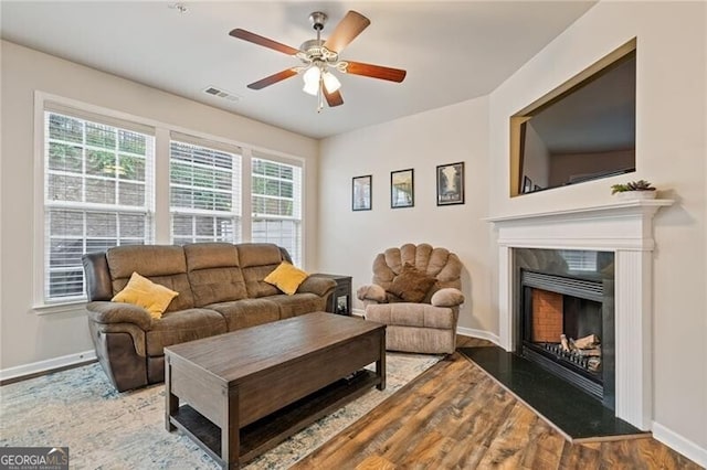 living room with hardwood / wood-style flooring, ceiling fan, and plenty of natural light