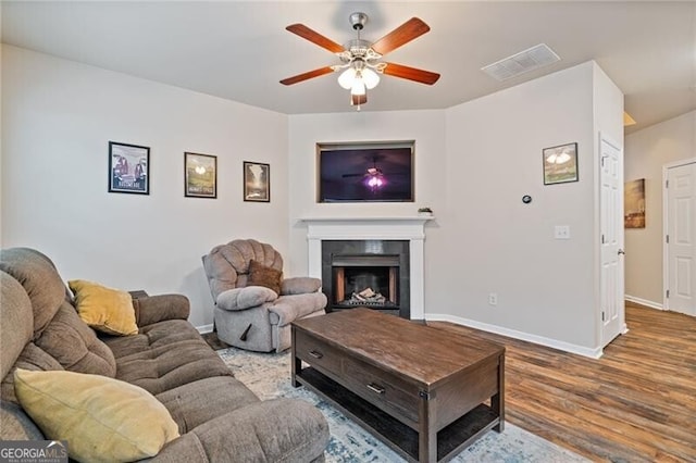 living room featuring hardwood / wood-style floors and ceiling fan