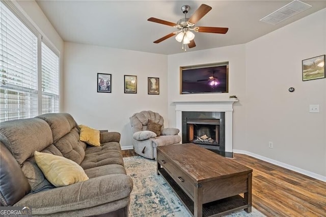 living room featuring wood-type flooring and ceiling fan