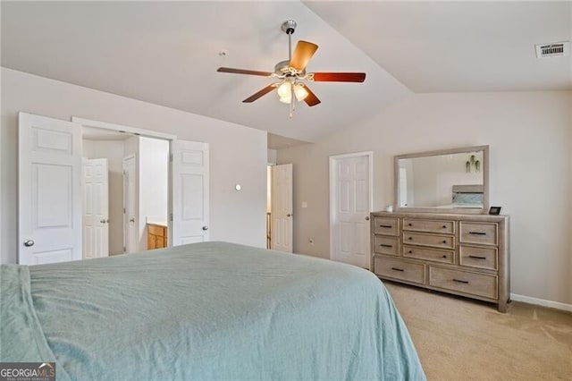 carpeted bedroom with ceiling fan and vaulted ceiling