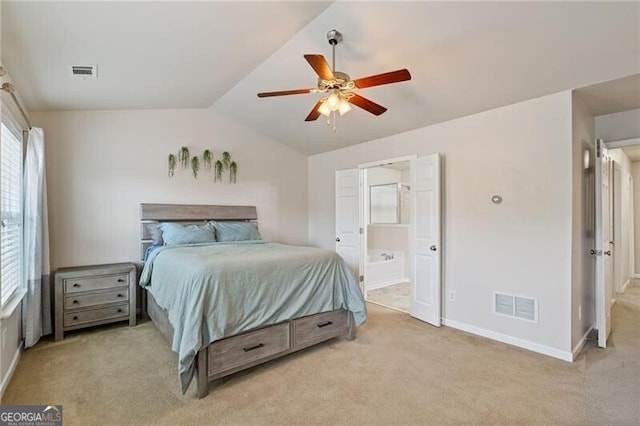 carpeted bedroom with lofted ceiling, ceiling fan, and ensuite bath