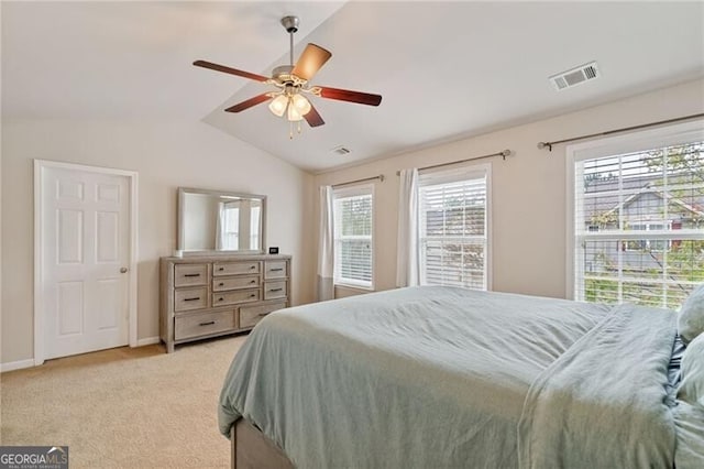 bedroom featuring ceiling fan, light carpet, and vaulted ceiling