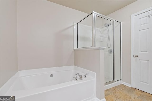 bathroom with tile patterned flooring and separate shower and tub