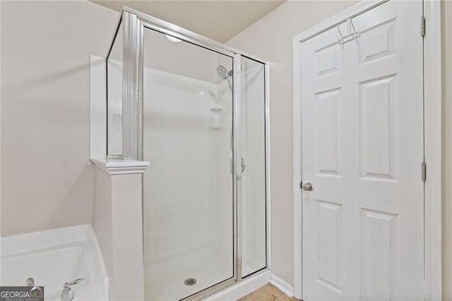 bathroom featuring shower with separate bathtub