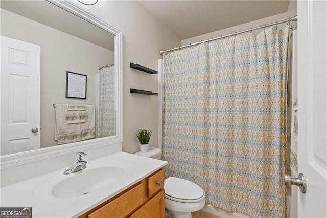 bathroom with toilet and vanity