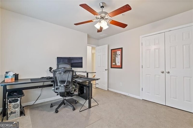 home office featuring ceiling fan and light carpet