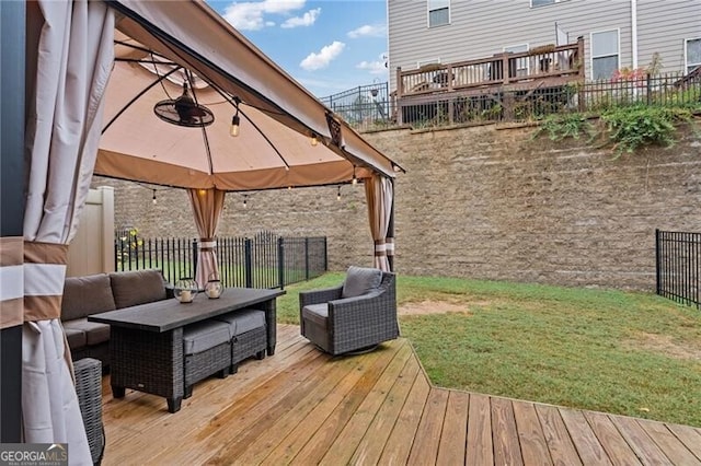 deck featuring a yard, an outdoor hangout area, and a gazebo