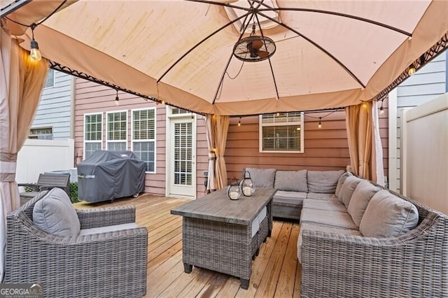 wooden terrace featuring a grill, a gazebo, and an outdoor living space