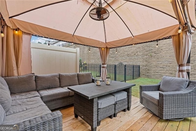 deck with outdoor lounge area and a gazebo