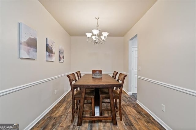 dining area with a chandelier and dark hardwood / wood-style floors