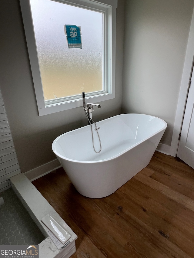 bathroom featuring a tub and wood-type flooring