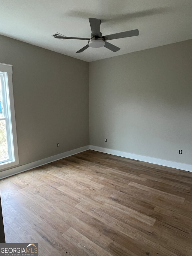 spare room featuring ceiling fan and light hardwood / wood-style flooring