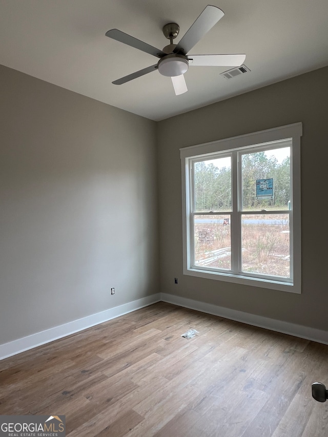 empty room featuring light wood-type flooring and ceiling fan