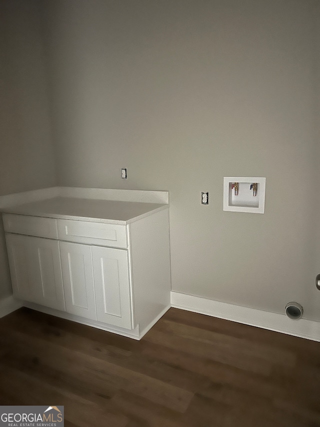 clothes washing area with washer hookup and dark hardwood / wood-style flooring