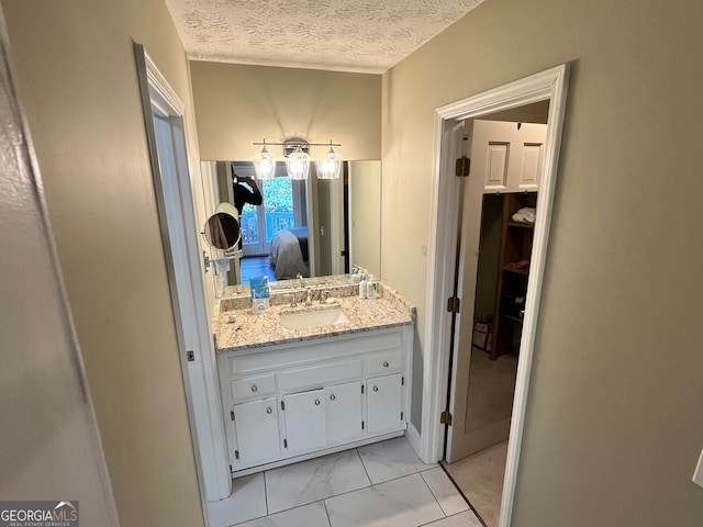 bathroom with vanity and a textured ceiling