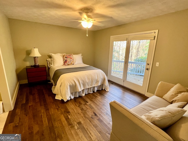 bedroom with access to exterior, a textured ceiling, ceiling fan, and dark wood-type flooring