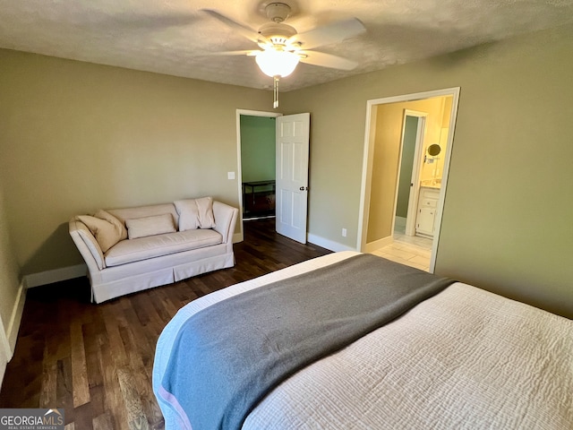 bedroom with a textured ceiling, dark hardwood / wood-style flooring, ensuite bathroom, and ceiling fan