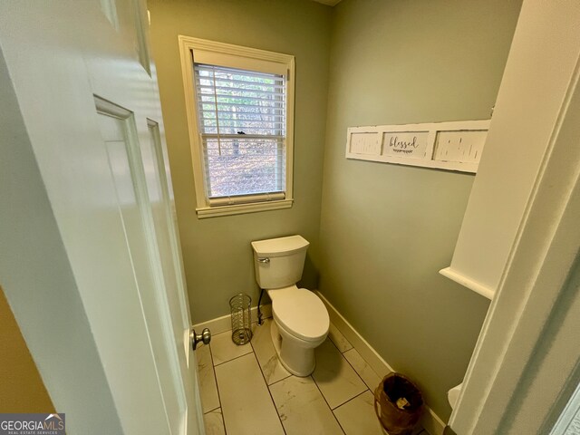 bathroom with tile patterned flooring and toilet