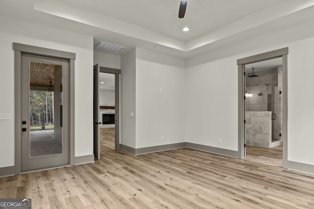 spare room featuring ceiling fan and light hardwood / wood-style floors