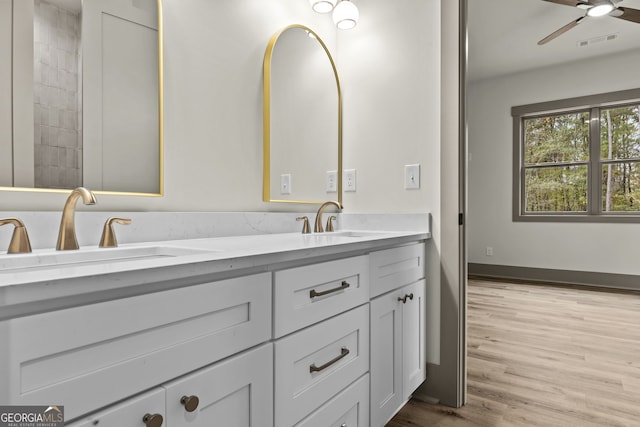 bathroom with wood-type flooring, ceiling fan, and vanity