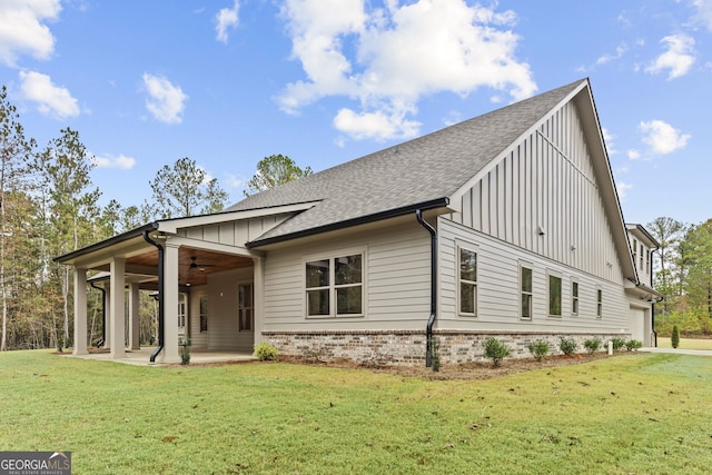 back of house with a lawn, ceiling fan, and a patio area