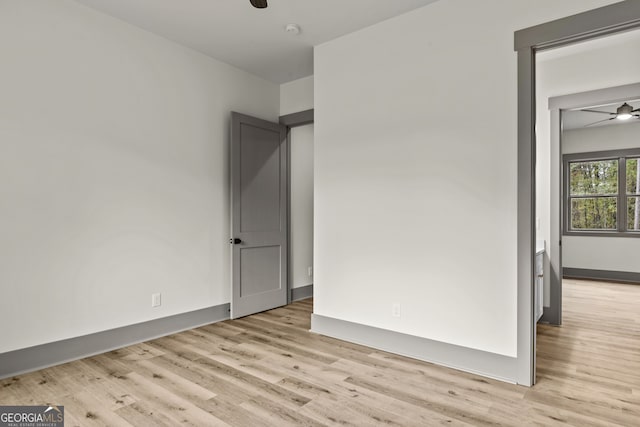 spare room featuring light wood-type flooring and ceiling fan