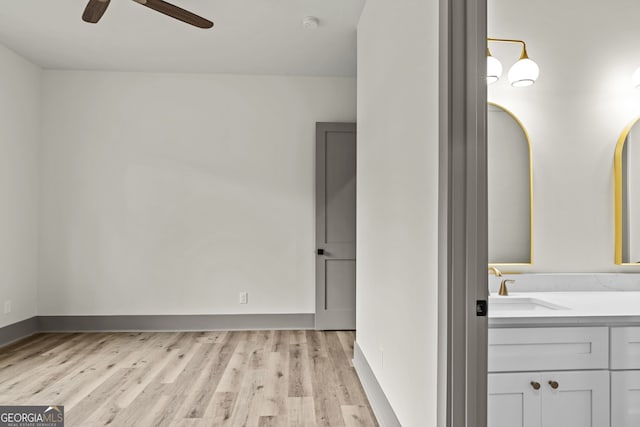 interior space featuring vanity, hardwood / wood-style floors, and ceiling fan