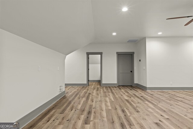 additional living space with light wood-type flooring, vaulted ceiling, and ceiling fan