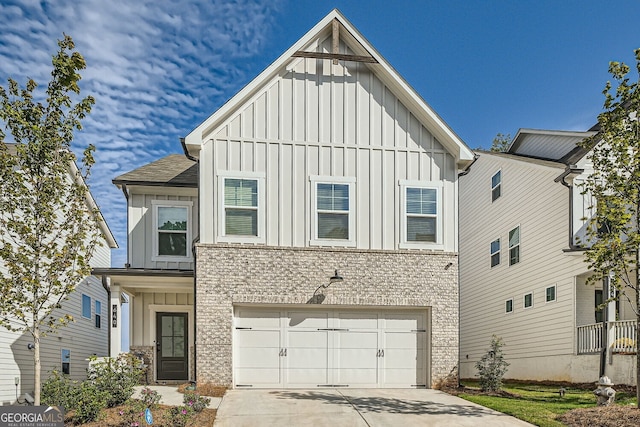 view of front of home with board and batten siding, concrete driveway, brick siding, and an attached garage