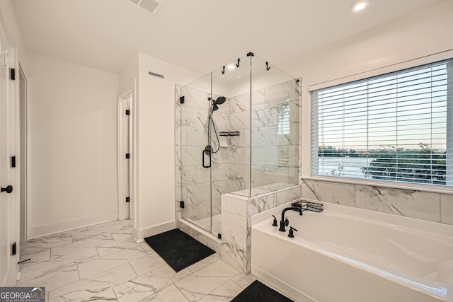 bathroom featuring separate shower and tub