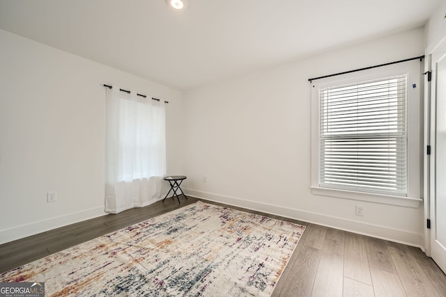 empty room featuring dark wood-type flooring