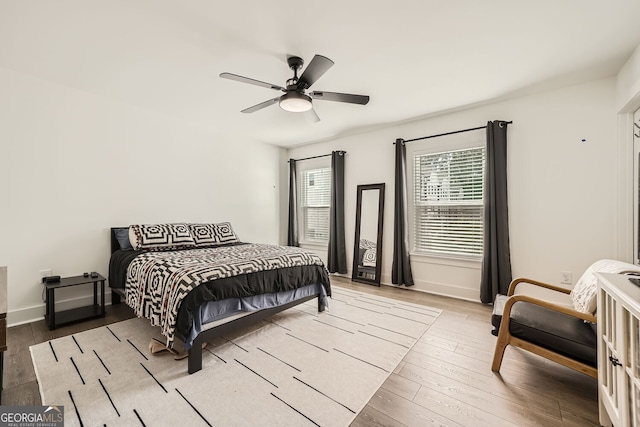 bedroom featuring light hardwood / wood-style floors and ceiling fan