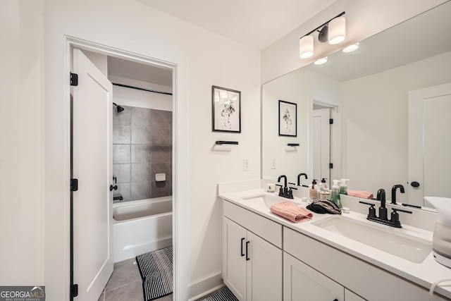 bathroom featuring tile patterned flooring, vanity, and tiled shower / bath combo