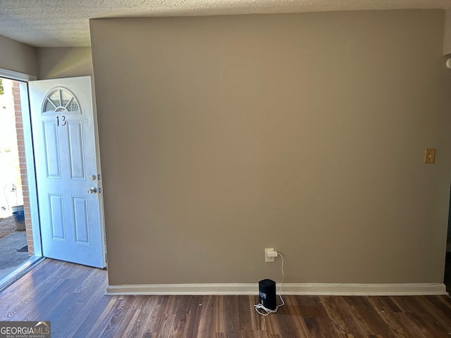 entryway with a textured ceiling and dark hardwood / wood-style floors