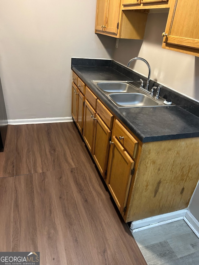 kitchen featuring dark wood-type flooring and sink