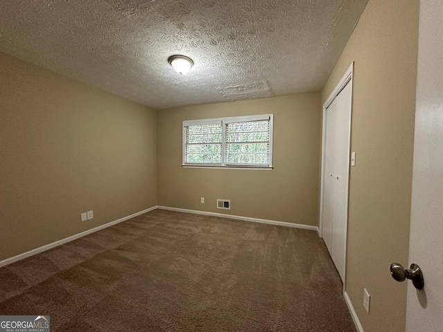 2929 Stratford Mill Rd, Lithonia, GA 30038 - unfurnished bedroom with carpet floors, a textured ceiling, baseboards, and a closet