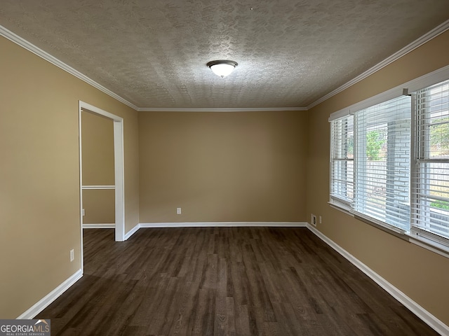 spare room featuring dark hardwood / wood-style flooring, a textured ceiling, and ornamental molding