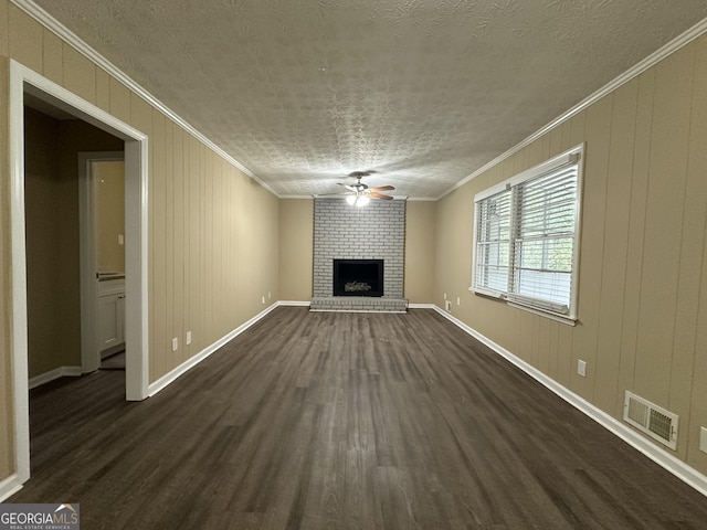2929 Stratford Mill Rd, Lithonia, GA 30038 - unfurnished living room featuring a ceiling fan, dark wood-style flooring, ornamental molding, a brick fireplace, and baseboards
