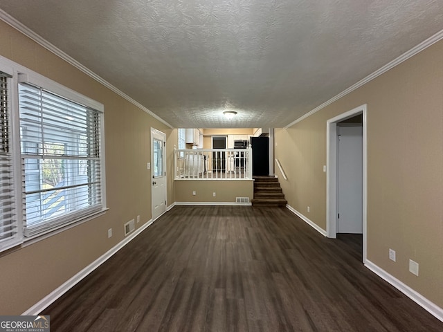 unfurnished living room with a textured ceiling, dark hardwood / wood-style floors, and crown molding