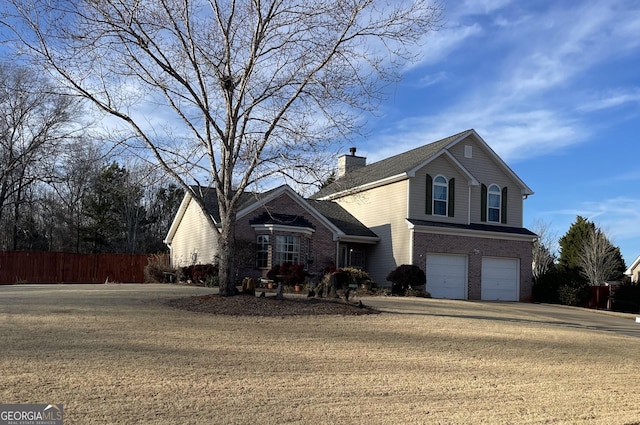 view of front property with a garage and a front yard