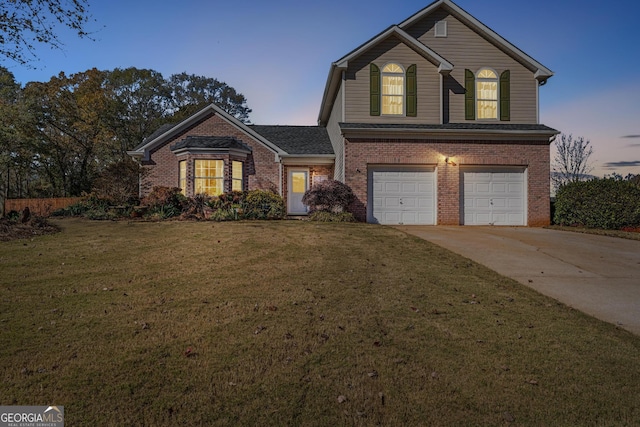 front facade with a garage and a yard