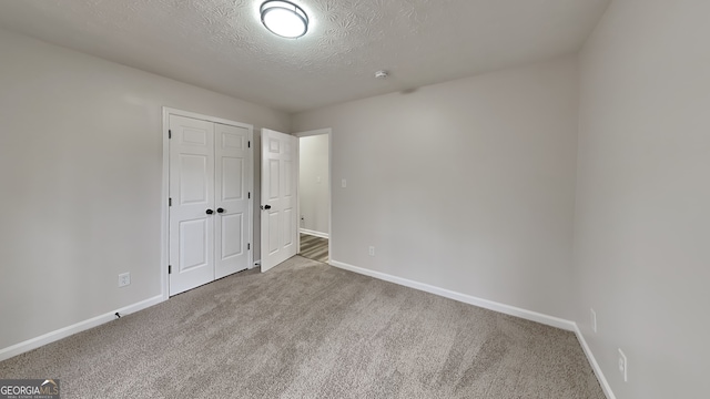245 Southmoor Cir, Stockbridge, GA 30281 - unfurnished bedroom with carpet floors, baseboards, a textured ceiling, and a closet