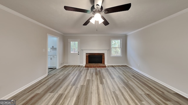 unfurnished living room featuring a brick fireplace, light hardwood / wood-style floors, ceiling fan, and ornamental molding