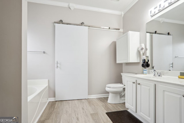 bathroom with wood-type flooring, toilet, vanity, crown molding, and a bath