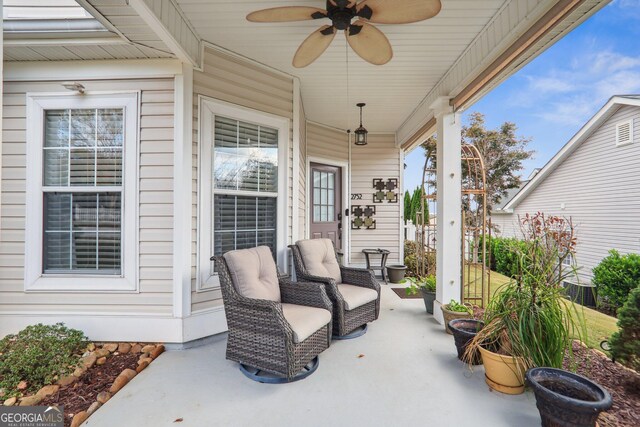 view of patio with ceiling fan and a porch