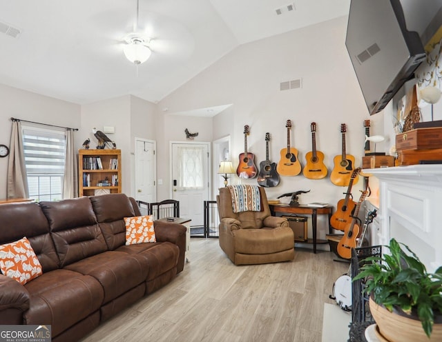 living room featuring light wood-type flooring, lofted ceiling, and ceiling fan