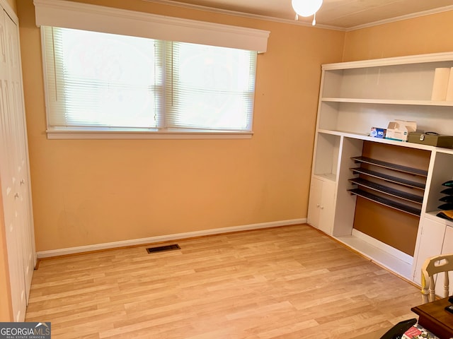 unfurnished bedroom with light hardwood / wood-style flooring and crown molding