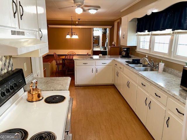 kitchen featuring sink, decorative light fixtures, white cabinets, white stove, and exhaust hood