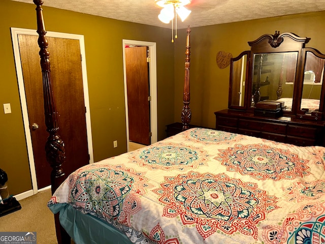 bedroom with carpet floors and a textured ceiling